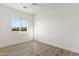 Bedroom with wood floors, window, and a neutral color palette at 15582 W Jomax Rd, Surprise, AZ 85387