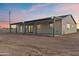 Newly built home featuring a spacious covered patio with modern lighting, perfect for outdoor relaxation and entertaining at 15582 W Jomax Rd, Surprise, AZ 85387