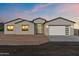 Charming single-story home with a modern design, desert landscaping, and a two-car garage at 15582 W Jomax Rd, Surprise, AZ 85387
