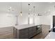 Kitchen island with stainless steel appliances and shaker cabinets in an open concept living space at 15582 W Jomax Rd, Surprise, AZ 85387