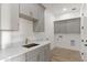 Laundry room with gray cabinets, stone countertops, and washer/dryer hookups at 15582 W Jomax Rd, Surprise, AZ 85387