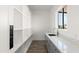 Bright walk-in pantry with custom shelving, granite countertop, and undermount sink at 15582 W Jomax Rd, Surprise, AZ 85387