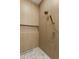 Shower stall featuring a rainfall shower head, shelf, and mosaic tile flooring at 15582 W Jomax Rd, Surprise, AZ 85387