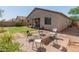Well-maintained backyard with seating around a fire pit at 17056 W Bristol Ln, Surprise, AZ 85374