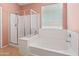 Bathroom showcasing a separate glass-enclosed shower and relaxing soaking tub with jets at 17056 W Bristol Ln, Surprise, AZ 85374