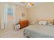 Cozy bedroom features a ceiling fan, a dresser, a comfortable bed, and neutral tones at 17056 W Bristol Ln, Surprise, AZ 85374