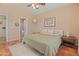 Serene bedroom offers a comfortable bed, neutral walls, and a view into the en suite bathroom at 17056 W Bristol Ln, Surprise, AZ 85374