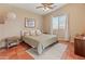 Cozy bedroom features a ceiling fan, natural light, and a stylish throw blanket and decor at 17056 W Bristol Ln, Surprise, AZ 85374