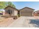 Charming single-story home featuring a low-maintenance desert landscape and a two-car garage at 17056 W Bristol Ln, Surprise, AZ 85374