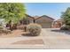 Charming single-story home showcasing desert landscaping, a spacious driveway, and an attached two-car garage at 17056 W Bristol Ln, Surprise, AZ 85374