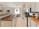 Modern kitchen featuring stainless steel appliances, white cabinets, and a cozy breakfast bar at 17056 W Bristol Ln, Surprise, AZ 85374