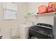 Laundry room features a white washer and a black dryer at 17056 W Bristol Ln, Surprise, AZ 85374