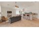 Spacious living room featuring tile floors, high ceilings, and an open layout to kitchen and dining at 17056 W Bristol Ln, Surprise, AZ 85374