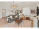 Comfortable living room with a ceiling fan, natural light, and a sliding glass door to the backyard at 17056 W Bristol Ln, Surprise, AZ 85374