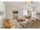 Open-concept living room flows into dining area, showcasing comfortable furniture and natural light at 17056 W Bristol Ln, Surprise, AZ 85374
