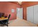A view of the home office with carpet, door to the outside, and a large closet at 17056 W Bristol Ln, Surprise, AZ 85374