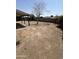 Spacious dirt backyard with a covered patio area and block fence for privacy at 1818 N 63Rd Ave, Phoenix, AZ 85035