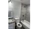 Updated bathroom showcasing marble tile walls, modern fixtures, and granite countertops at 1818 N 63Rd Ave, Phoenix, AZ 85035