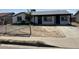 Traditional single-story home with dark trim, covered porch, and low fence at 1818 N 63Rd Ave, Phoenix, AZ 85035
