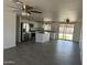 Bright, open kitchen features white cabinets, stainless appliances, and gray tile floors at 1818 N 63Rd Ave, Phoenix, AZ 85035