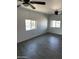 Bright living room featuring gray floors, recessed lighting, and two windows at 1818 N 63Rd Ave, Phoenix, AZ 85035