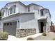 Charming two-story home with stone accents and a two-car garage showcasing modern curb appeal at 2339 E University Dr # 19, Mesa, AZ 85213