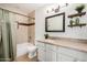 Bathroom featuring vanity with granite countertop, framed mirror, modern lighting, and tiled shower at 2406 S Mulberry --, Mesa, AZ 85202