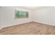 Bright bedroom with window overlooking greenery, and wood-look laminate flooring at 2406 S Mulberry --, Mesa, AZ 85202