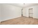 Bright bedroom featuring a closet, wood-look laminate flooring, and modern light fixture at 2406 S Mulberry --, Mesa, AZ 85202