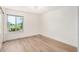Bright bedroom with window overlooking greenery, and wood-look laminate flooring at 2406 S Mulberry --, Mesa, AZ 85202