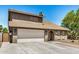 This home has a light gray exterior, a two-car garage, and desert landscaping in the front yard at 2406 S Mulberry --, Mesa, AZ 85202