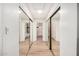 Bright hallway featuring mirrored closet doors, modern lighting, and entrances to a well-lit bathroom at 2406 S Mulberry --, Mesa, AZ 85202