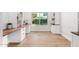 Home office has wood floors, a large window, built-in shelving, and a desk area at 2406 S Mulberry --, Mesa, AZ 85202