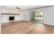 Bright living room featuring hardwood floors and a charming brick fireplace at 2406 S Mulberry --, Mesa, AZ 85202