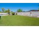 Landscaped backyard with artificial grass and rock accents at 2446 E Hale St, Mesa, AZ 85213