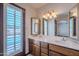 Bathroom featuring a dual sink vanity with a view of the pool at 2446 E Hale St, Mesa, AZ 85213