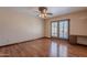 Well-lit bedroom with wood-look floors, ceiling fan, and pool access at 2446 E Hale St, Mesa, AZ 85213