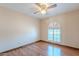 Bedroom with wood-look flooring and natural light from the shuttered window at 2446 E Hale St, Mesa, AZ 85213