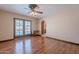 Bedroom with wood-look floors, ceiling fan, and convenient ensuite bathroom access at 2446 E Hale St, Mesa, AZ 85213