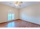 Bright bedroom with shuttered window, ceiling fan, and wood-look flooring at 2446 E Hale St, Mesa, AZ 85213
