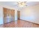 Bedroom featuring wood-look floors and a spacious closet with sliding doors at 2446 E Hale St, Mesa, AZ 85213