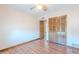 Bedroom with ceiling fan, wood-look floors, and a spacious closet at 2446 E Hale St, Mesa, AZ 85213