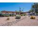 Well-maintained single-story home with desert landscaping, rock features, and mature palm trees in the yard at 2446 E Hale St, Mesa, AZ 85213