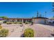 Inviting single-story home with a lush, drought-tolerant landscape and a charming front yard fountain at 2446 E Hale St, Mesa, AZ 85213