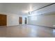 A spacious garage with two doors, a window, and overhead lighting at 2446 E Hale St, Mesa, AZ 85213