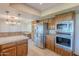A full kitchen view features stainless steel appliances and tile countertops at 2446 E Hale St, Mesa, AZ 85213