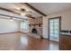 Open-concept living room features a brick fireplace and mini bar for entertaining at 2446 E Hale St, Mesa, AZ 85213