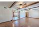Bright living area with wood flooring, exposed beams, and arched doorway at 2446 E Hale St, Mesa, AZ 85213