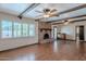 Spacious living room with wood floors, brick fireplace, and wood beam ceilings at 2446 E Hale St, Mesa, AZ 85213