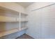 A pantry painted white with several shelves for storage at 2446 E Hale St, Mesa, AZ 85213